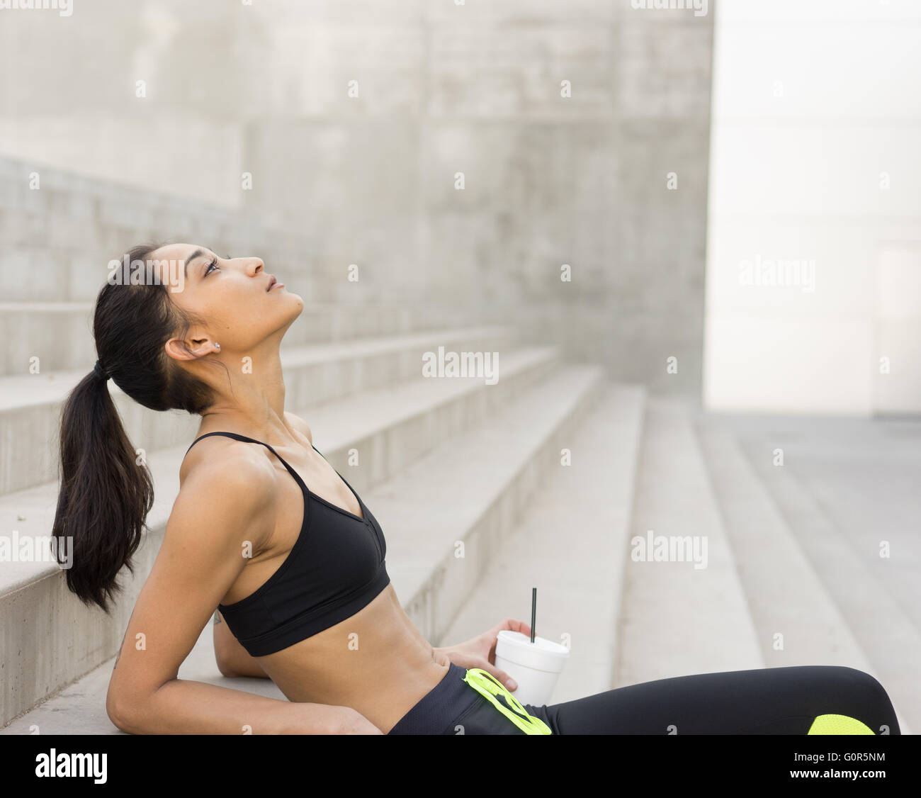 Young multi ethnic woman in exercise, gym, workout clothes, series of fitness wellness inspired imagery Stock Photo