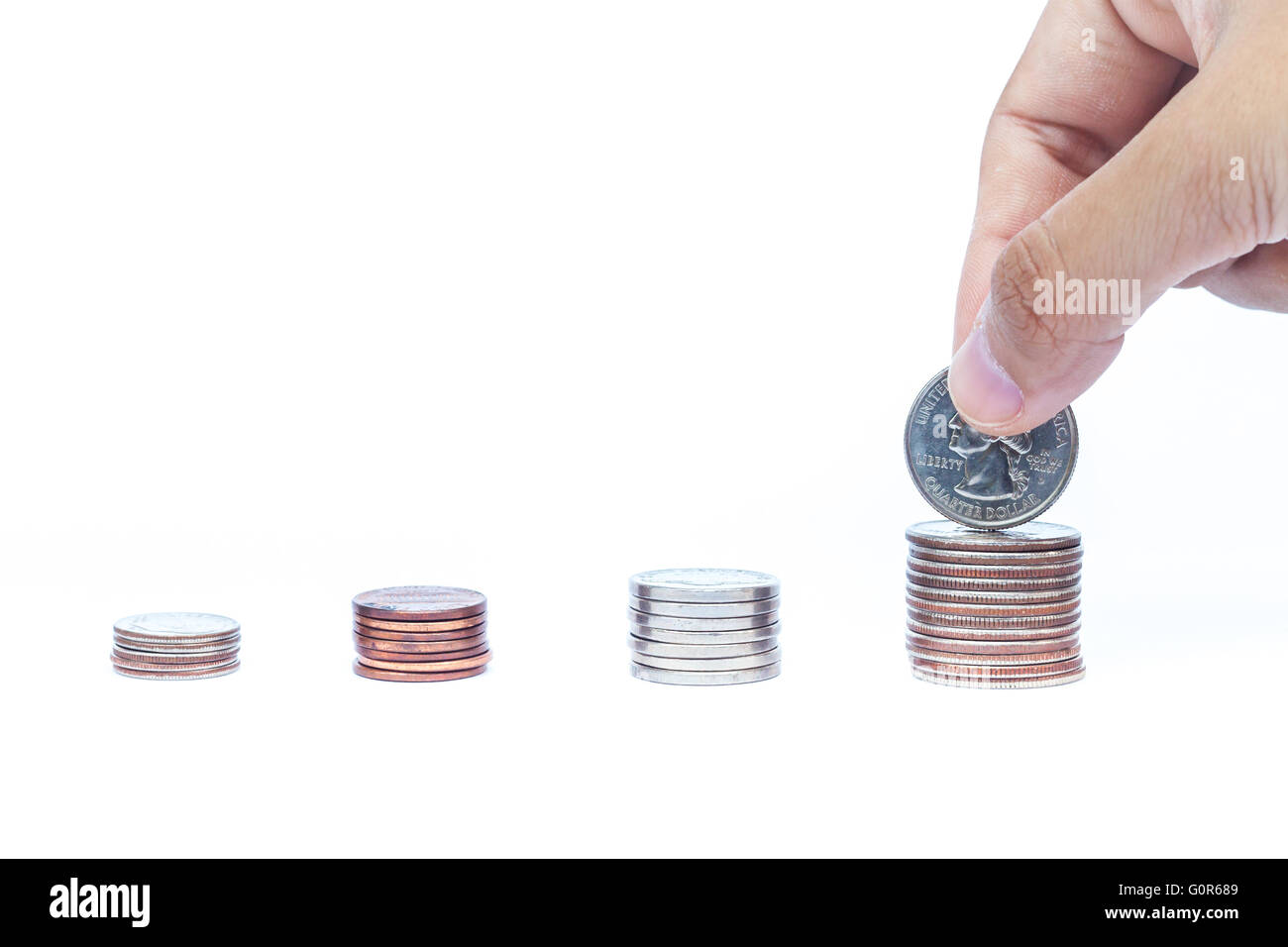 Woman hand putting money coin for saving money concept Stock Photo