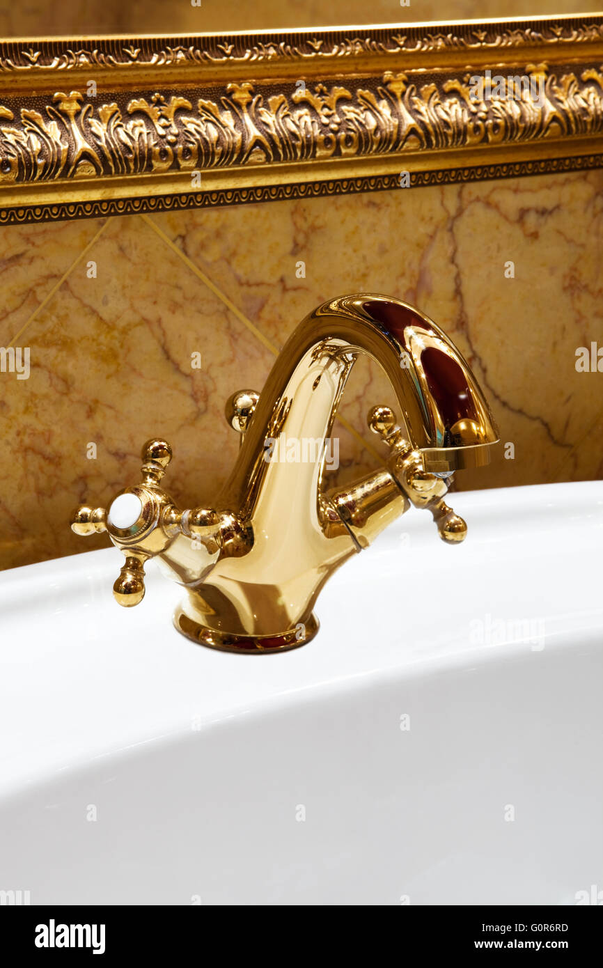 The beautiful water faucet from bronze in a bathroom Stock Photo - Alamy