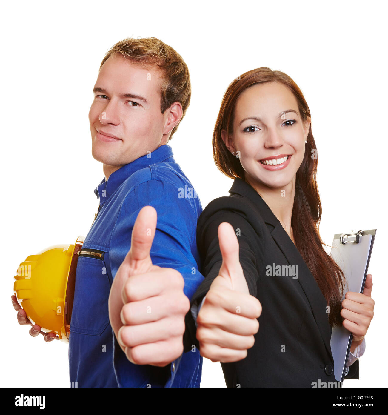 Worker and business woman holding thumbs up together and smiling Stock Photo