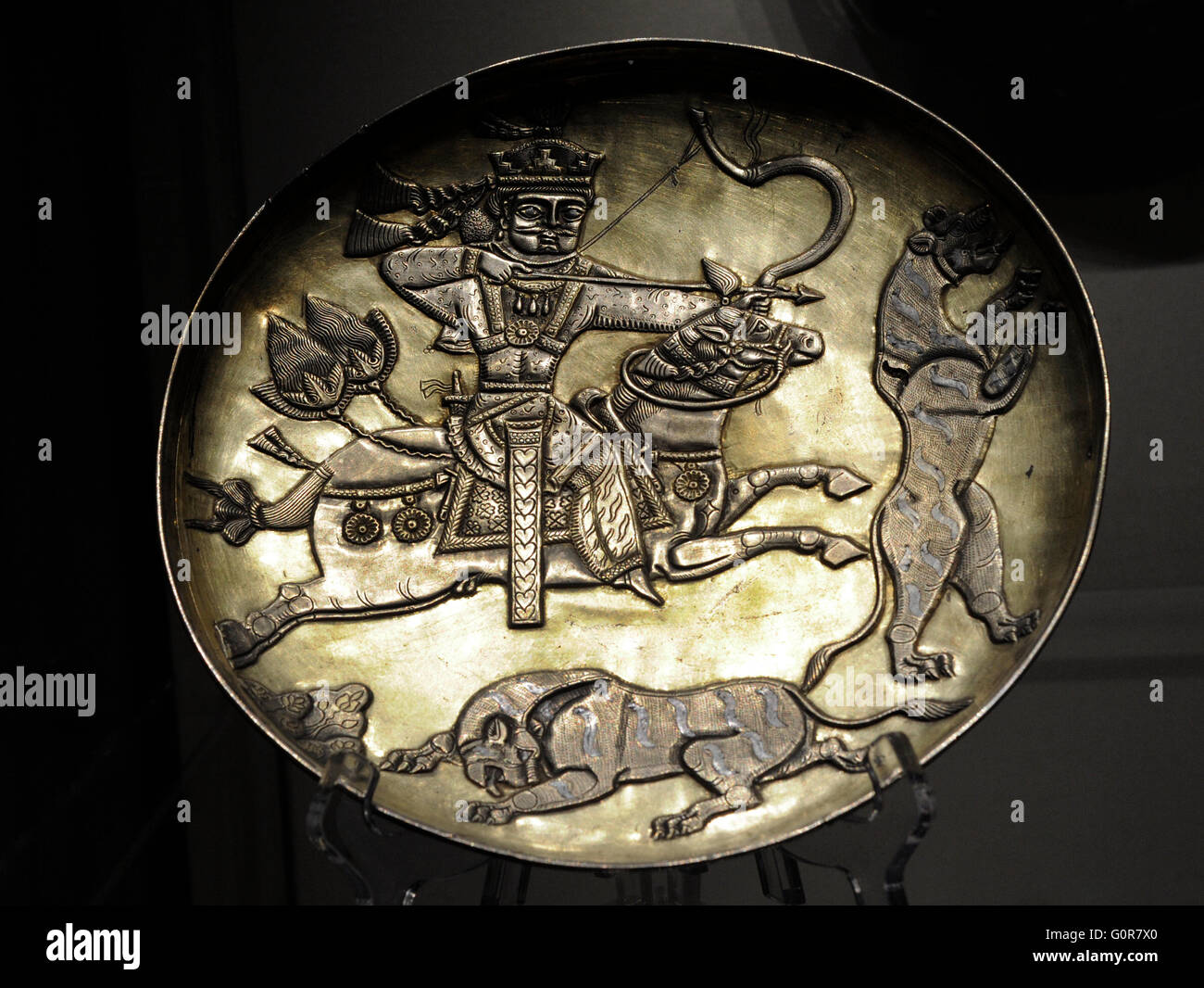 Sasanian Empire. Plate with the king hunting predators. Silver; chasing, gilding. Iran. 7th century. Found as part of a treasure in Perm Region. The State Hermitage Museum. Saint Petersburg. Russia. Stock Photo
