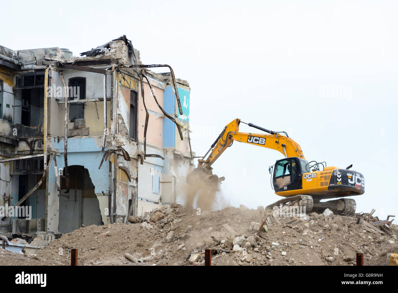 A bulldozer tears down an old building on the Malecon in Havana as part of Cuba's programme of modernisation and regeneration Stock Photo