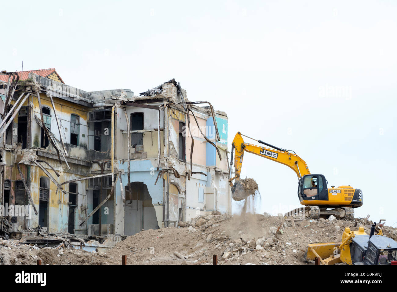 A bulldozer tears down an old building on the Malecon  in Havana as part of Cuba's programme of modernisation and regeneration Stock Photo