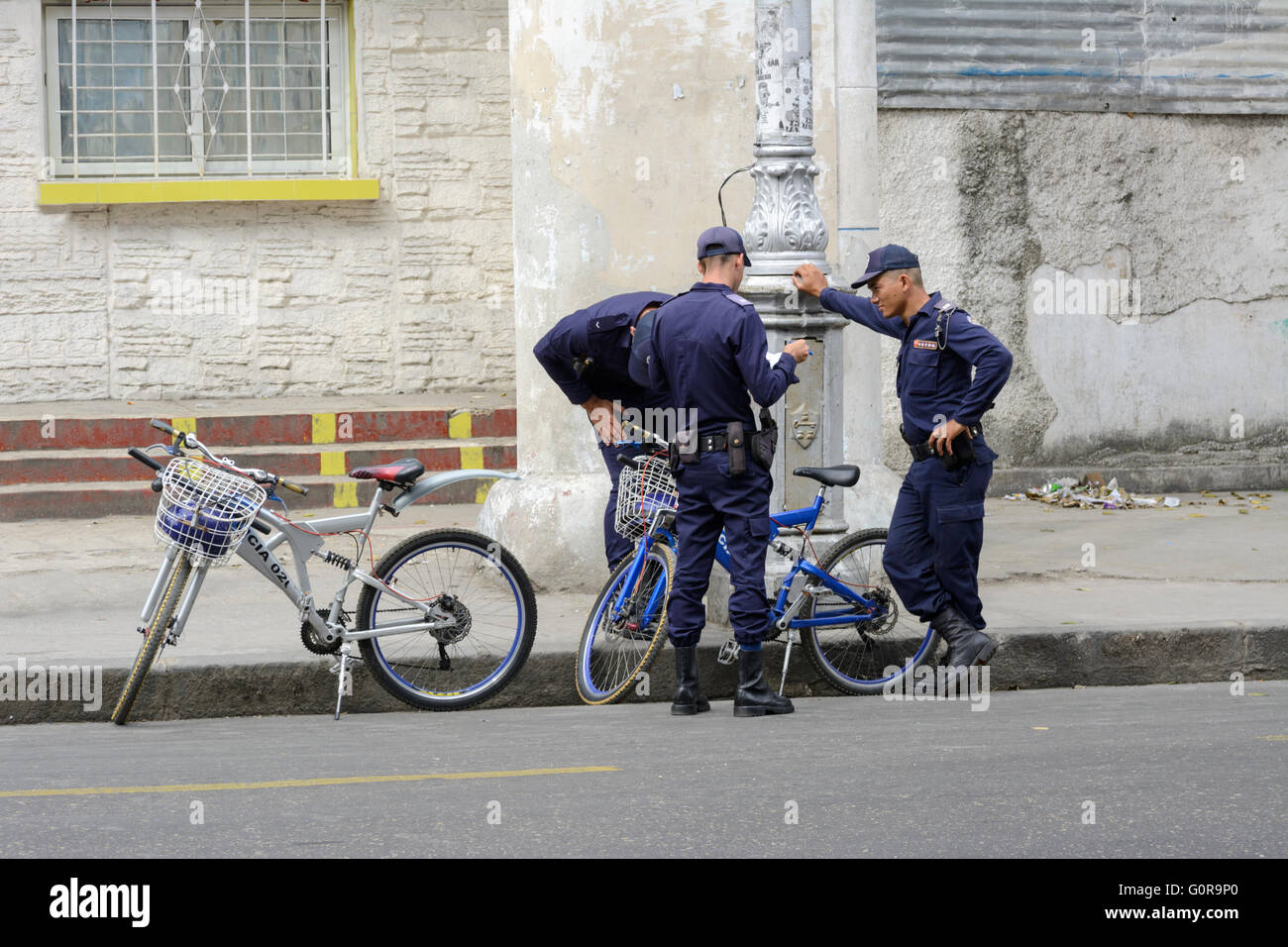 Three Cuban policemen on patrol with their bicycles in Havana, Cuba Stock Photo