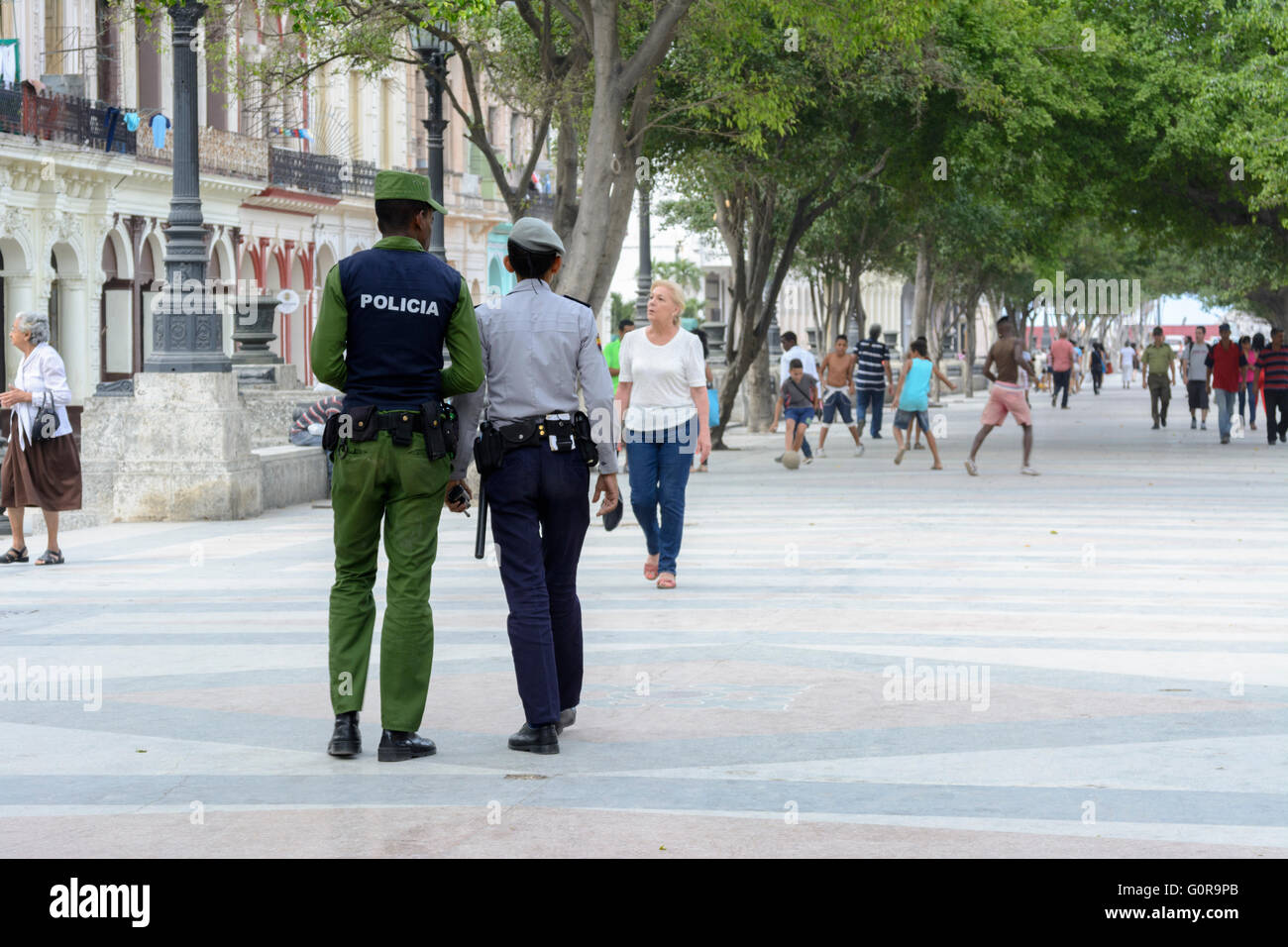 Two Cuban police officers patrolling the Prado in Havana, Cuba while