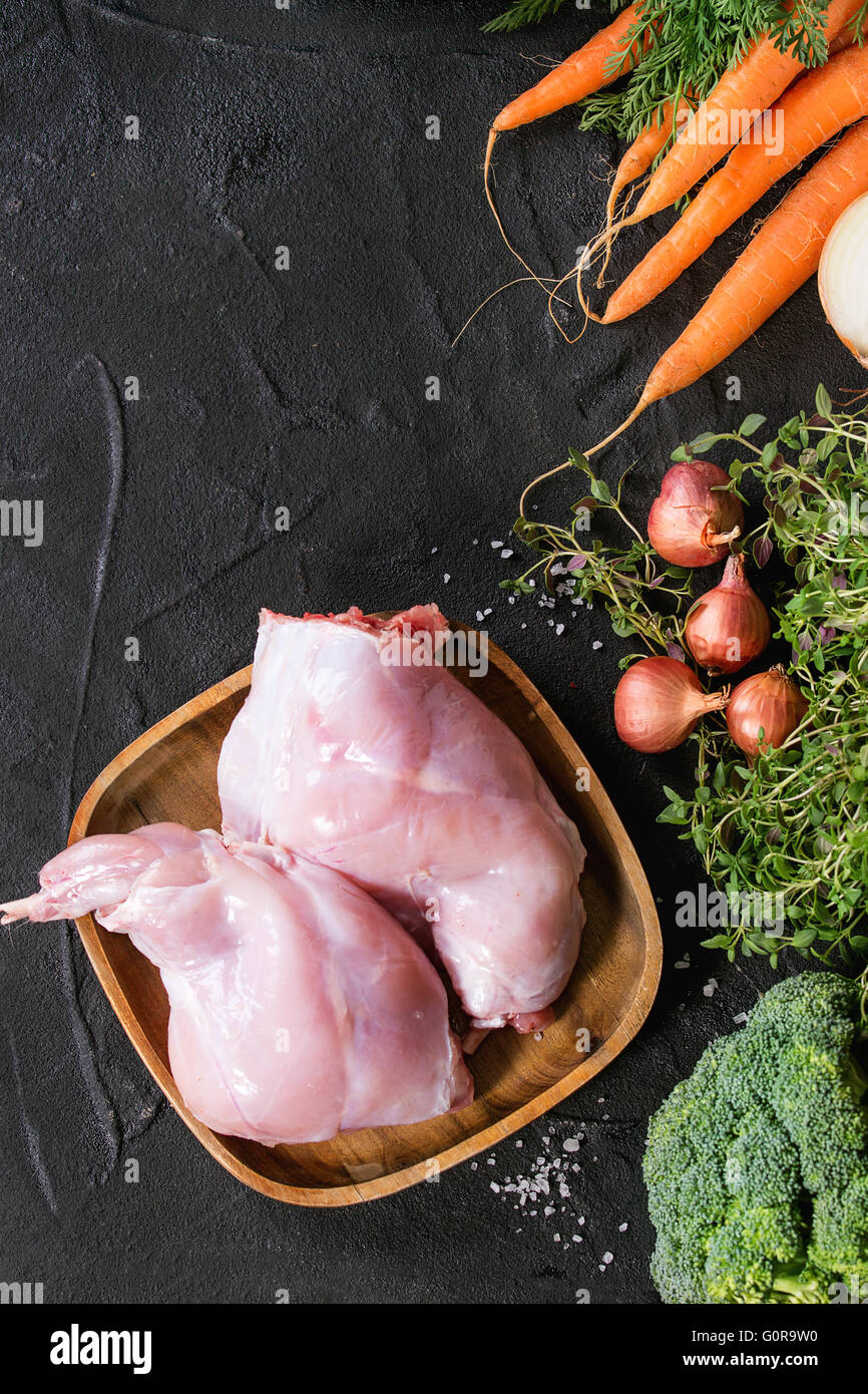 Raw rabbit legs with vegetables Stock Photo - Alamy