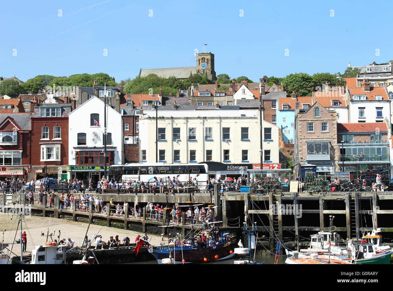 SOUTH BAY HARBOR, SCARBOROUGH, NORTH YORKSHIRE, ENGLAND - 19th of May 2014: Tourists enjoying a day out in the popular seaside Stock Photo