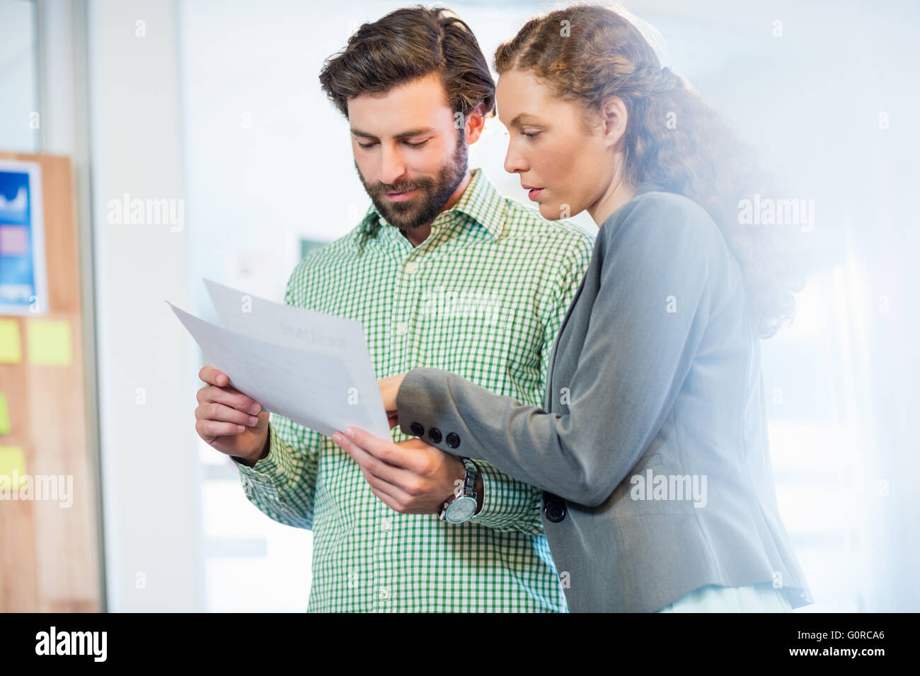 Businessman and businesswoman looking at diary Stock Photo