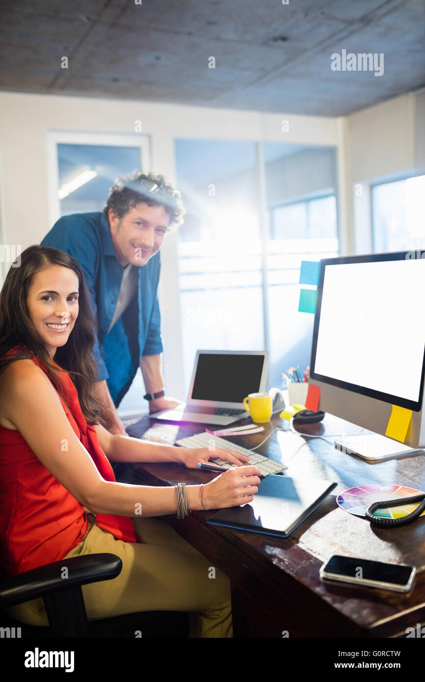 Colleagues using a graphic pad Stock Photo - Alamy