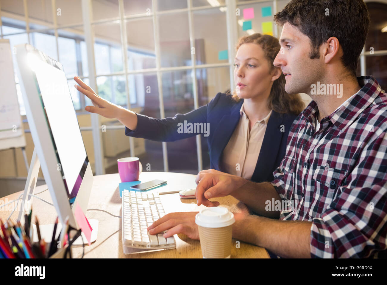 Colleagues using a computer Stock Photo
