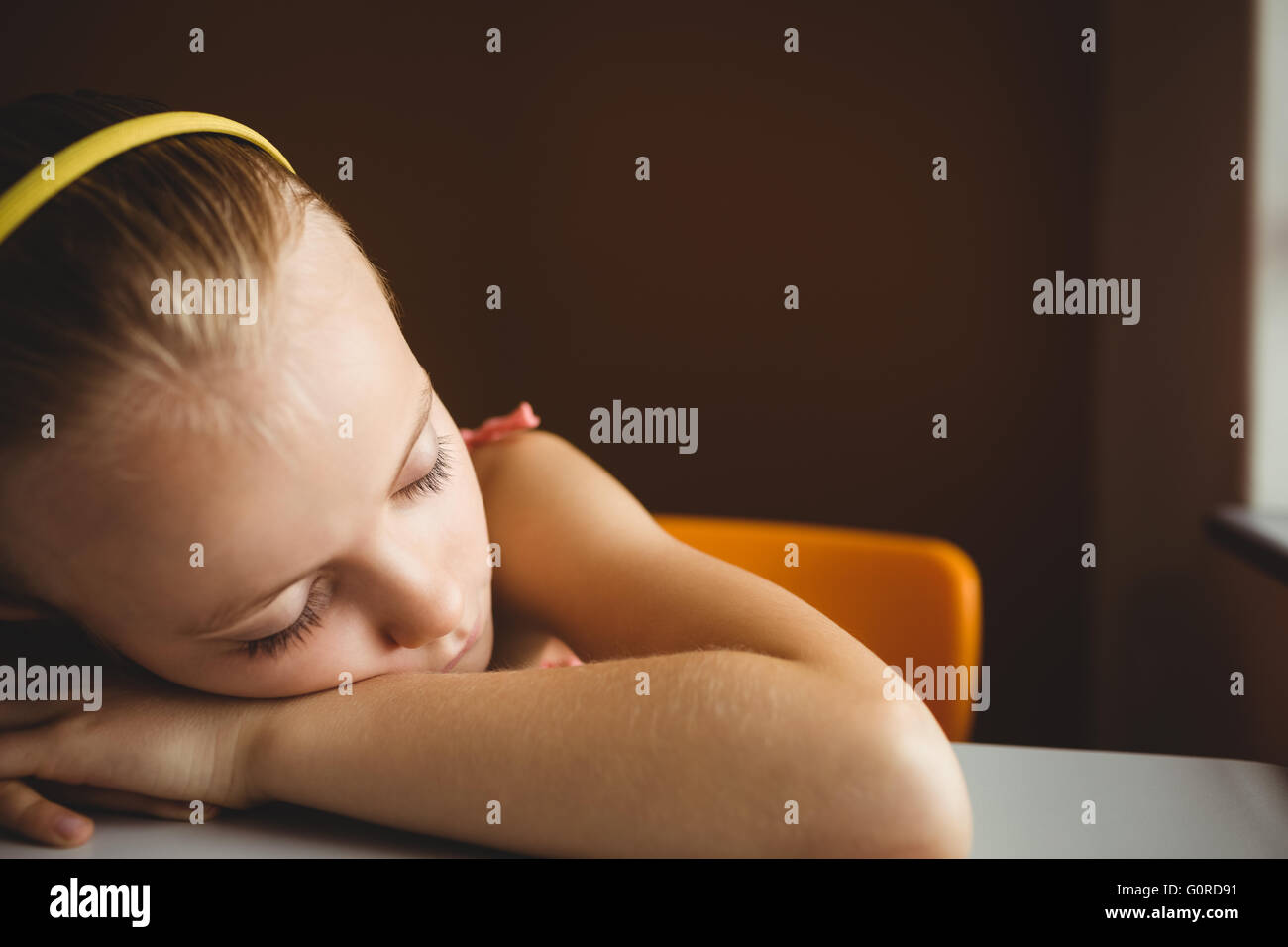 Schoolchild sleeping on desk Stock Photo