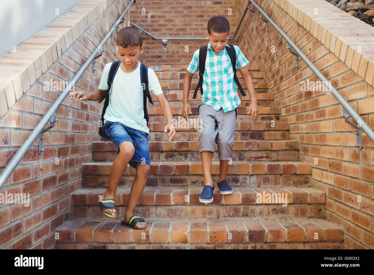 Kids going down the stairs Stock Photo