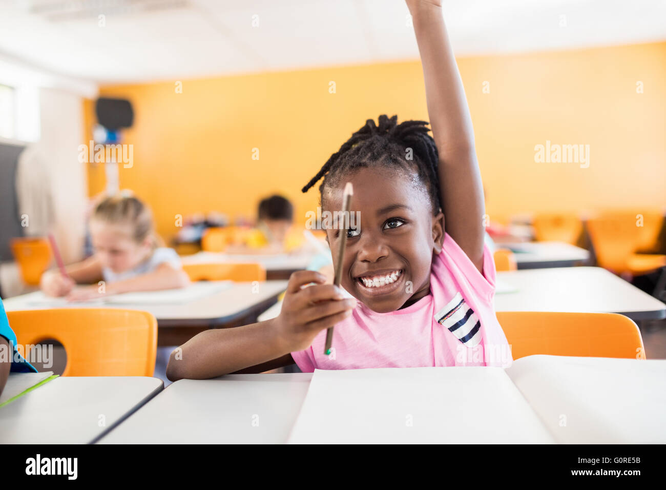 A cute pupil raising hand Stock Photo