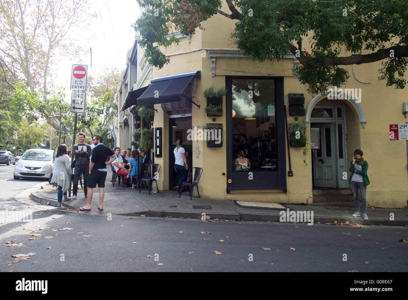People mingling outside a corner coffee shop in inner Sydney. Stock Photo