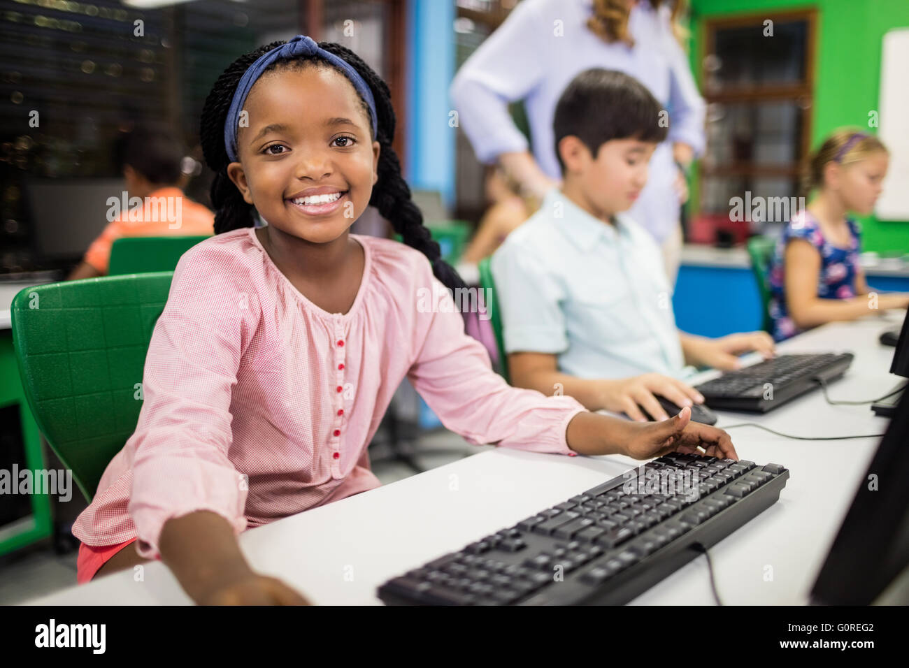 Children looking their computer Stock Photo - Alamy