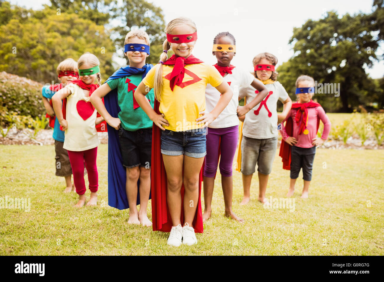 Children wearing superhero costume standing Stock Photo
