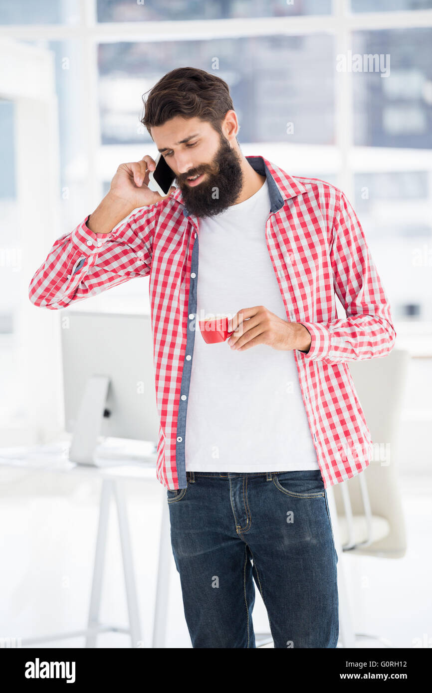 Hipster man is calling someone Stock Photo