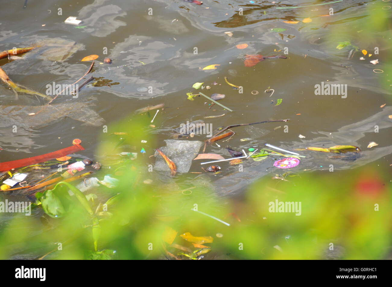 Plastic waste floating down a river causing pollution in a river in ...