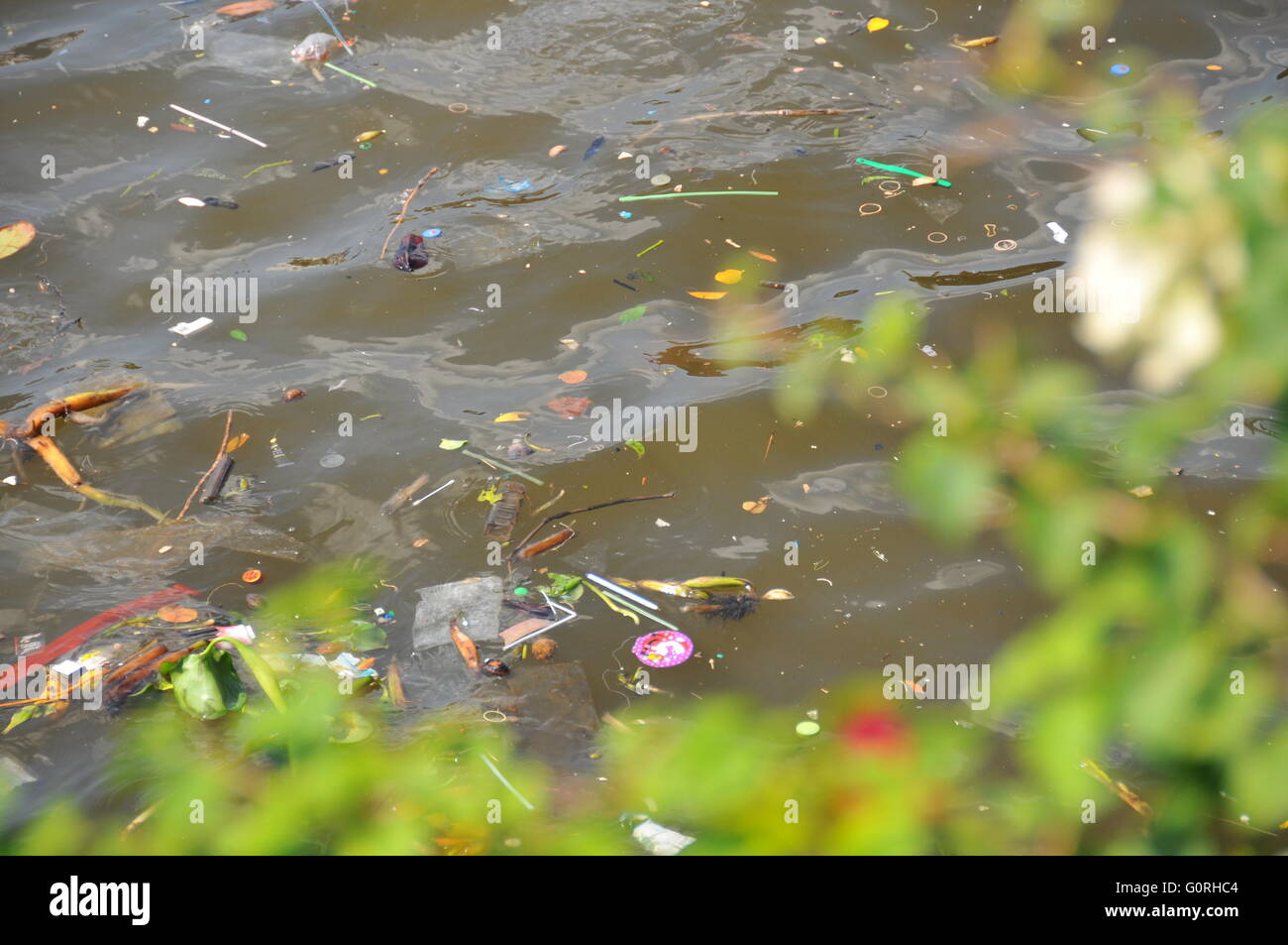 Plastic waste floating down a river causing pollution in a river in ...