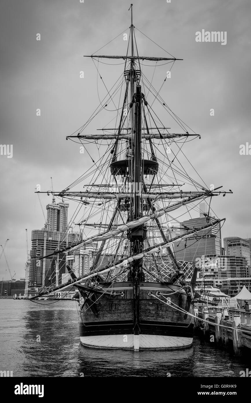 View of the replica of captain Cooks sailing ship HM Bark Endeavour on a cloudy day, black and white photography Stock Photo
