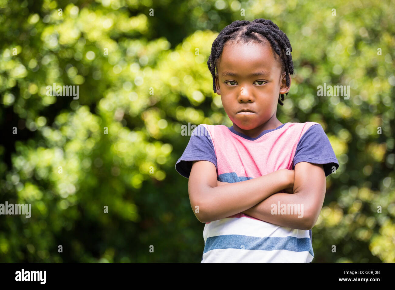 Angry boy with arms crossed Stock Photo
