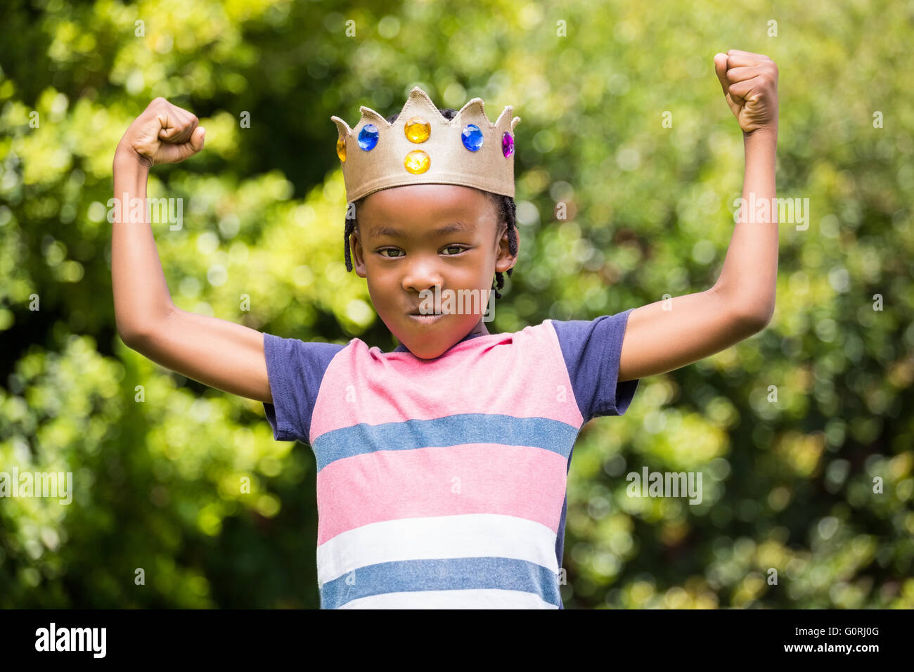 Boy showing his muscles Stock Photo
