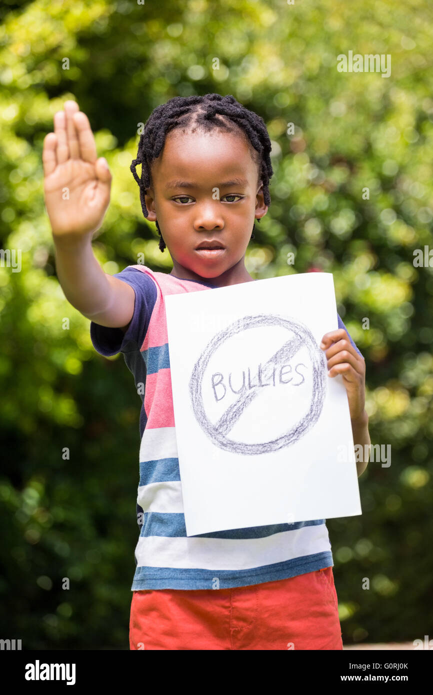 Boy saying stop with hand and paper Stock Photo