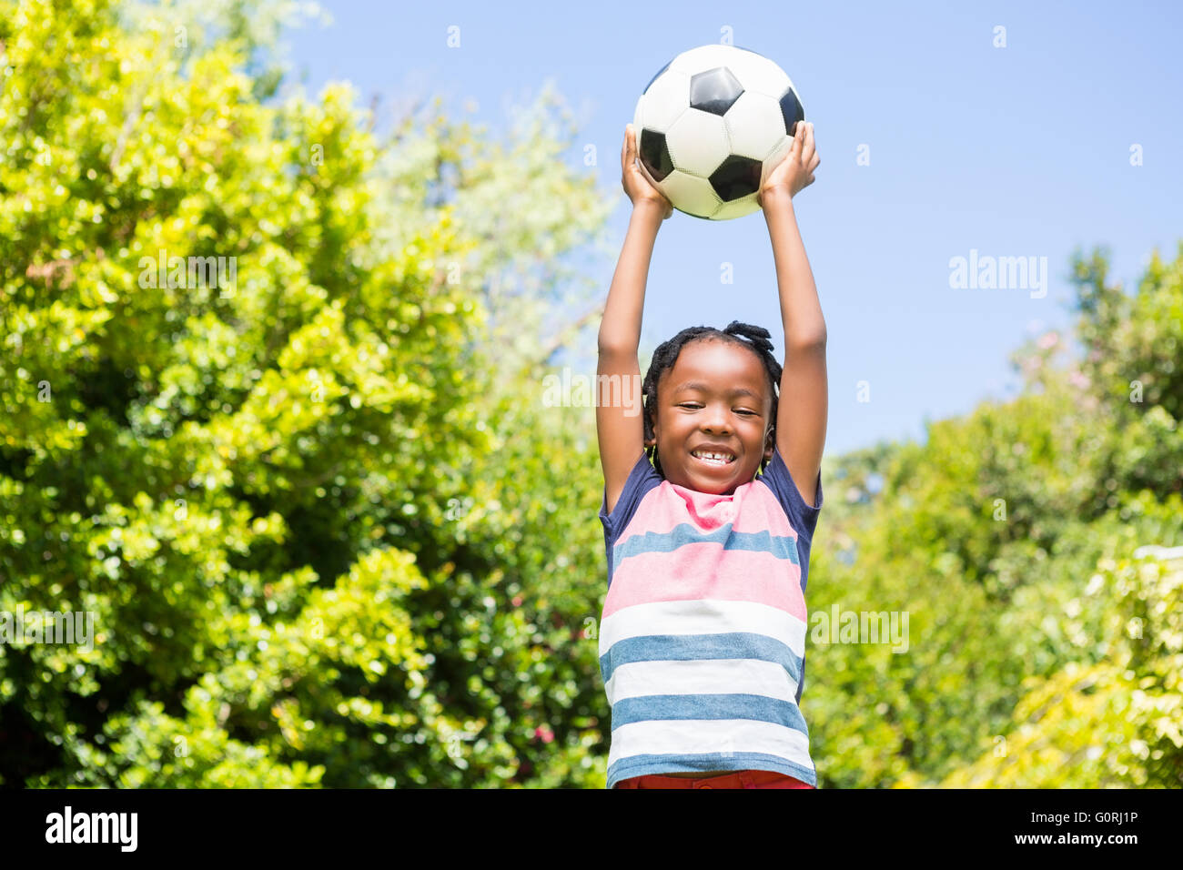 Smiling boy holding a ball Stock Photo