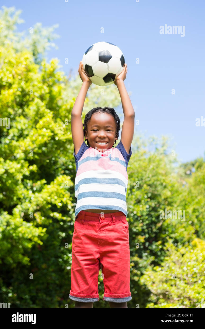 Smiling boy holding a ball Stock Photo