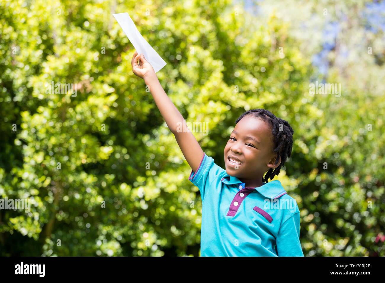 Smiling boy holding a paper Stock Photo