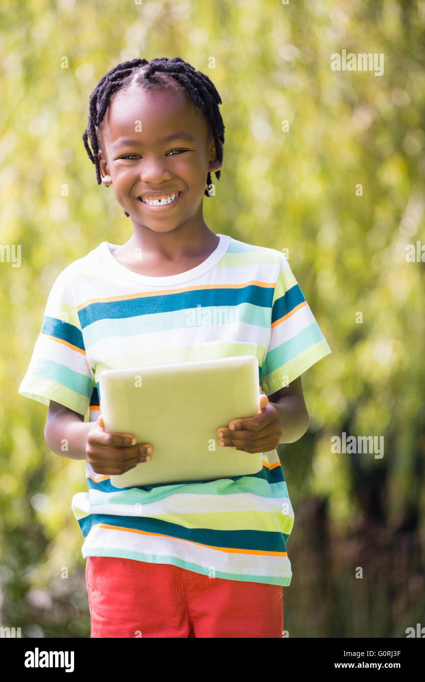 Portrait of kid holding a tablet computer Stock Photo