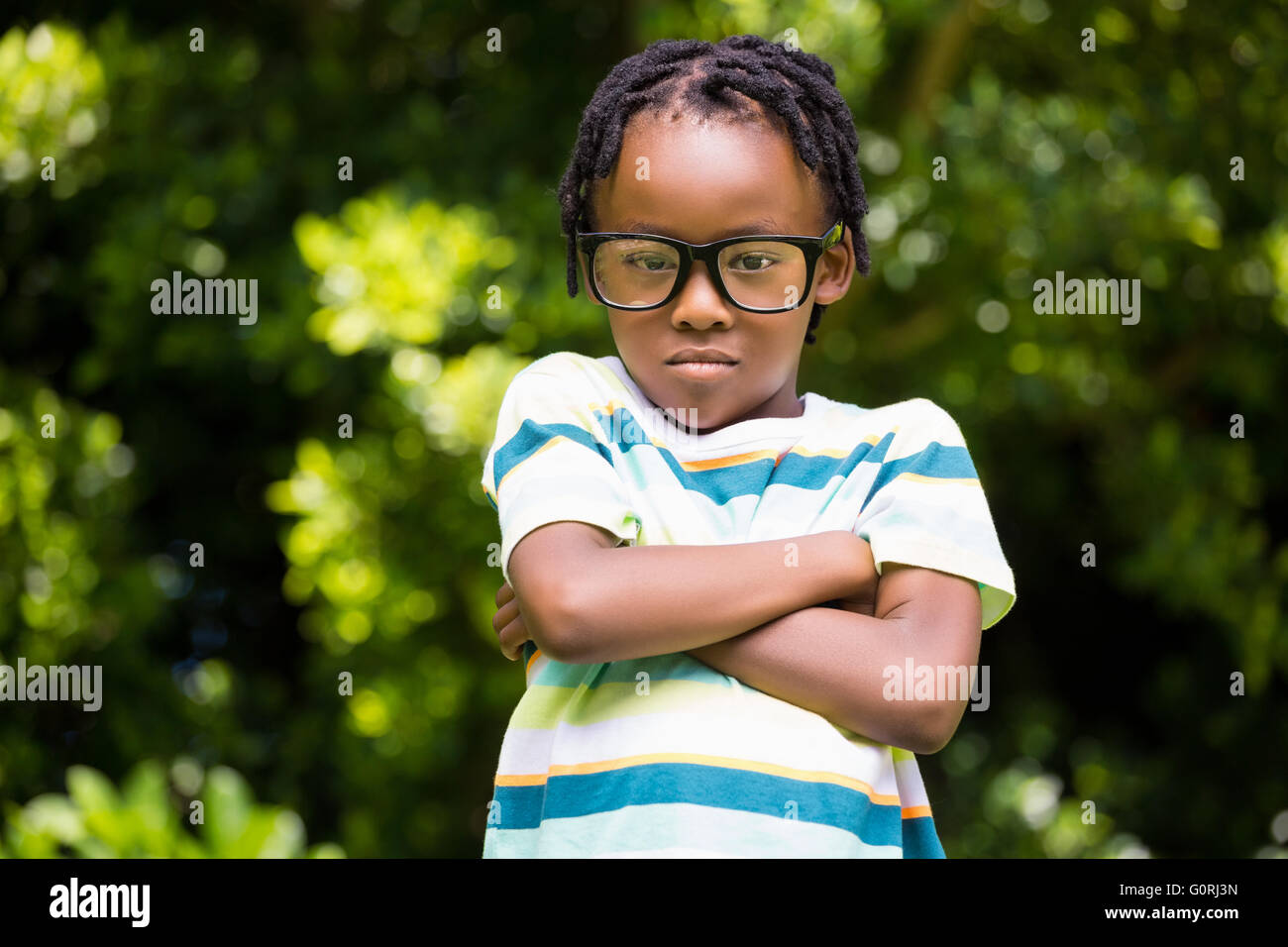 A kid posing with his arms crossed Stock Photo