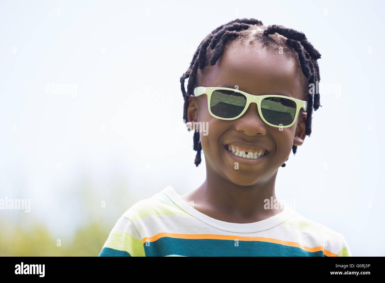 A kid with sunglasses smiling Stock Photo