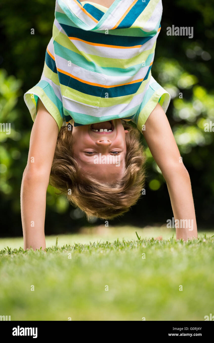 A little boy is playing upside down Stock Photo Alamy