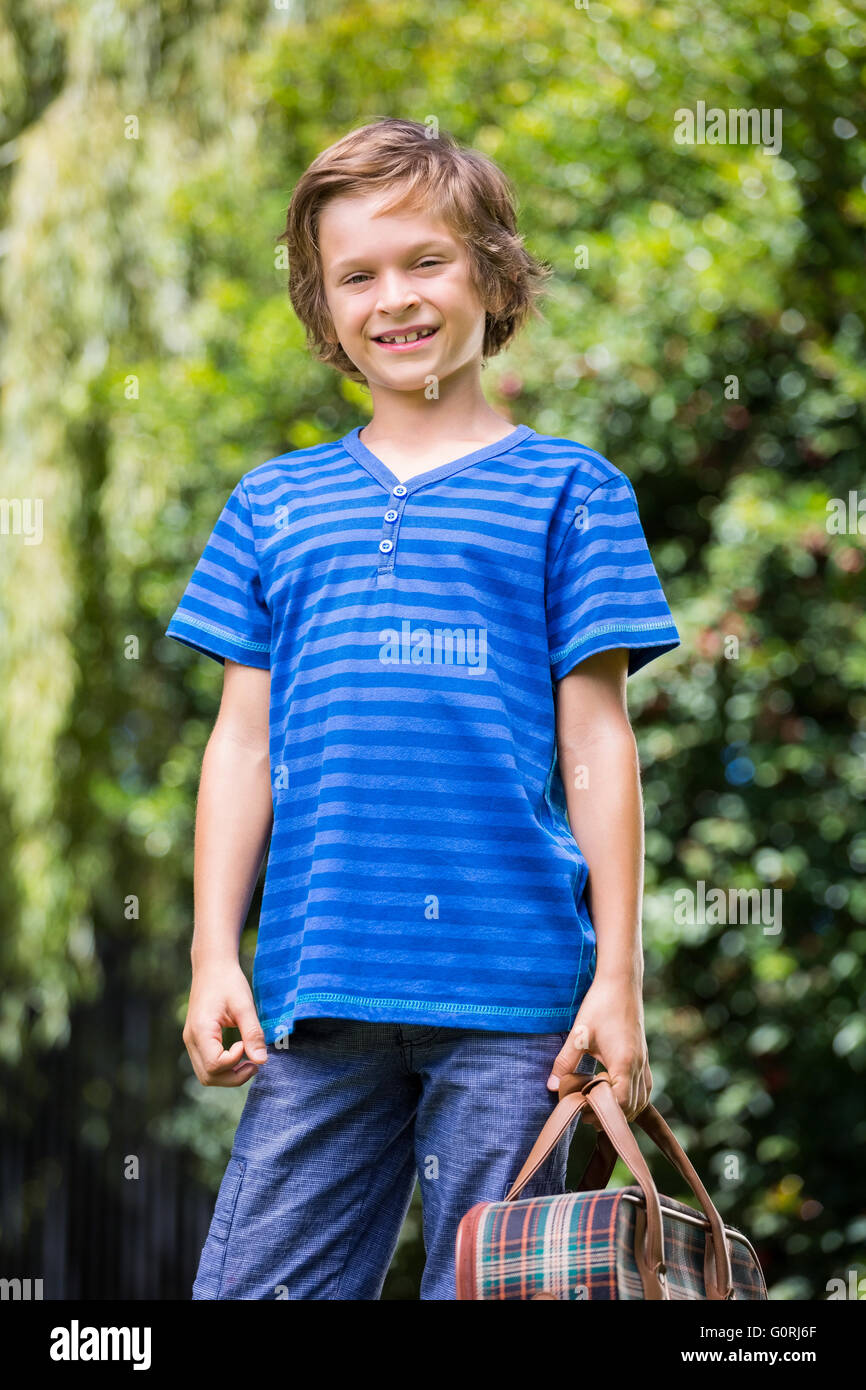 A little boy is holding a suitcase Stock Photo