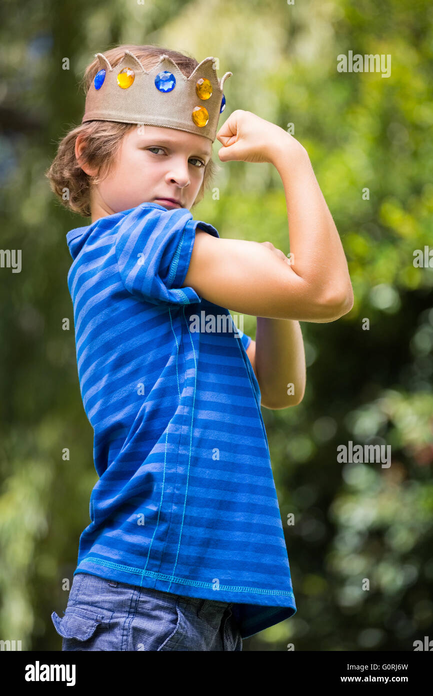Portrait of cute boy with a crown showing his muscle Stock Photo