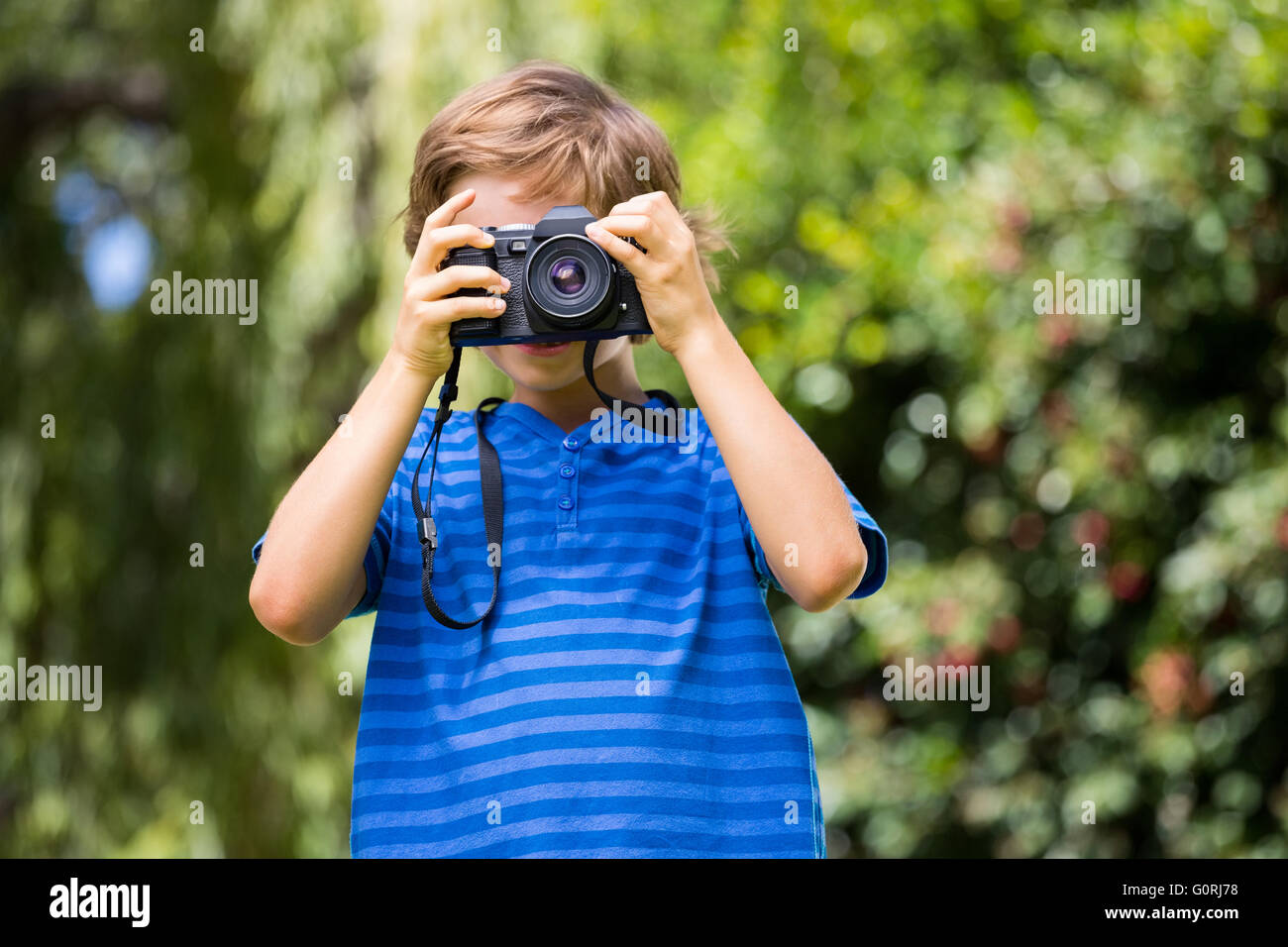 Portrait of young boy taking a photo face to the camera Stock Photo