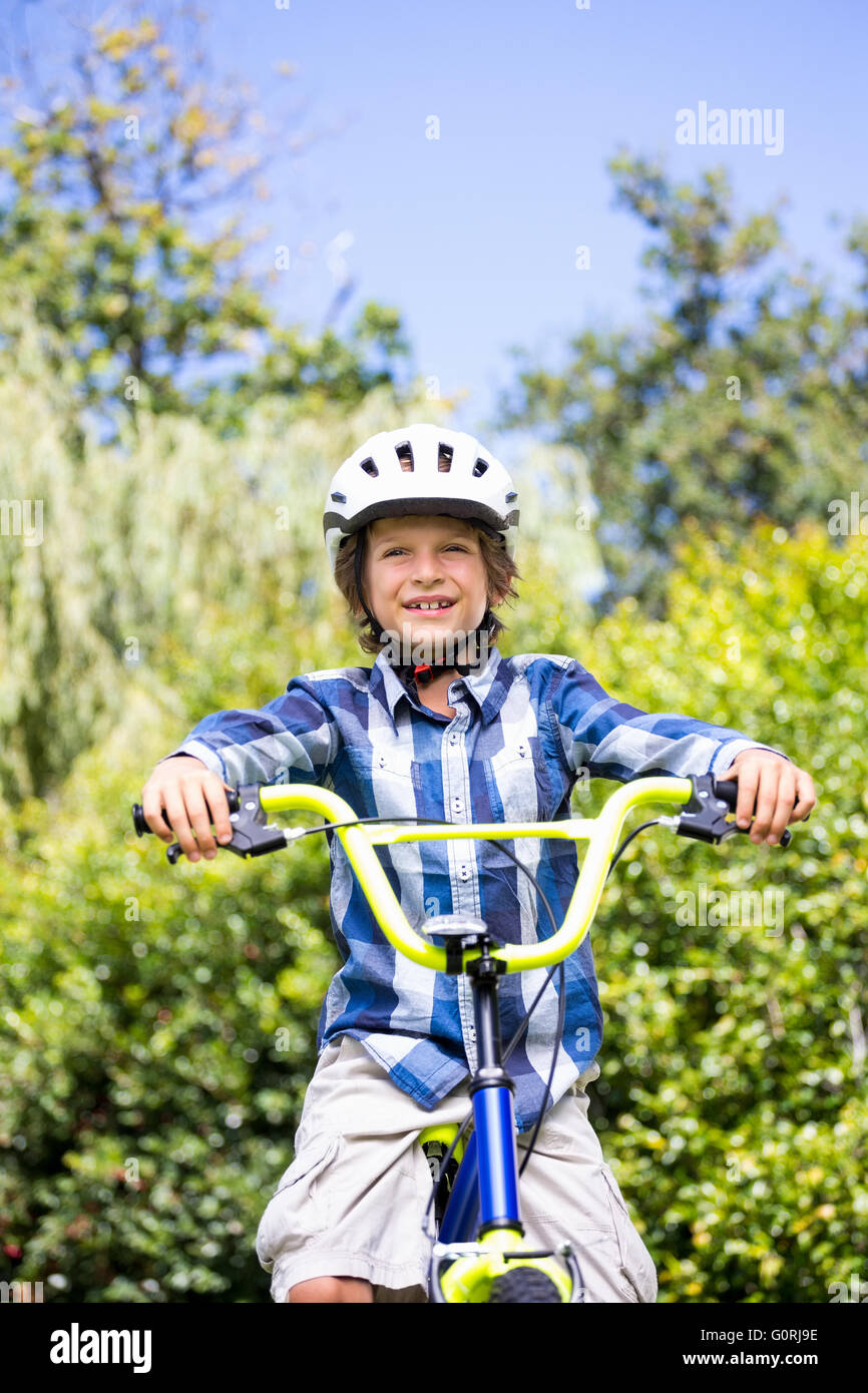 Portrait of cute boy smiling and posing on his bike Stock Photo