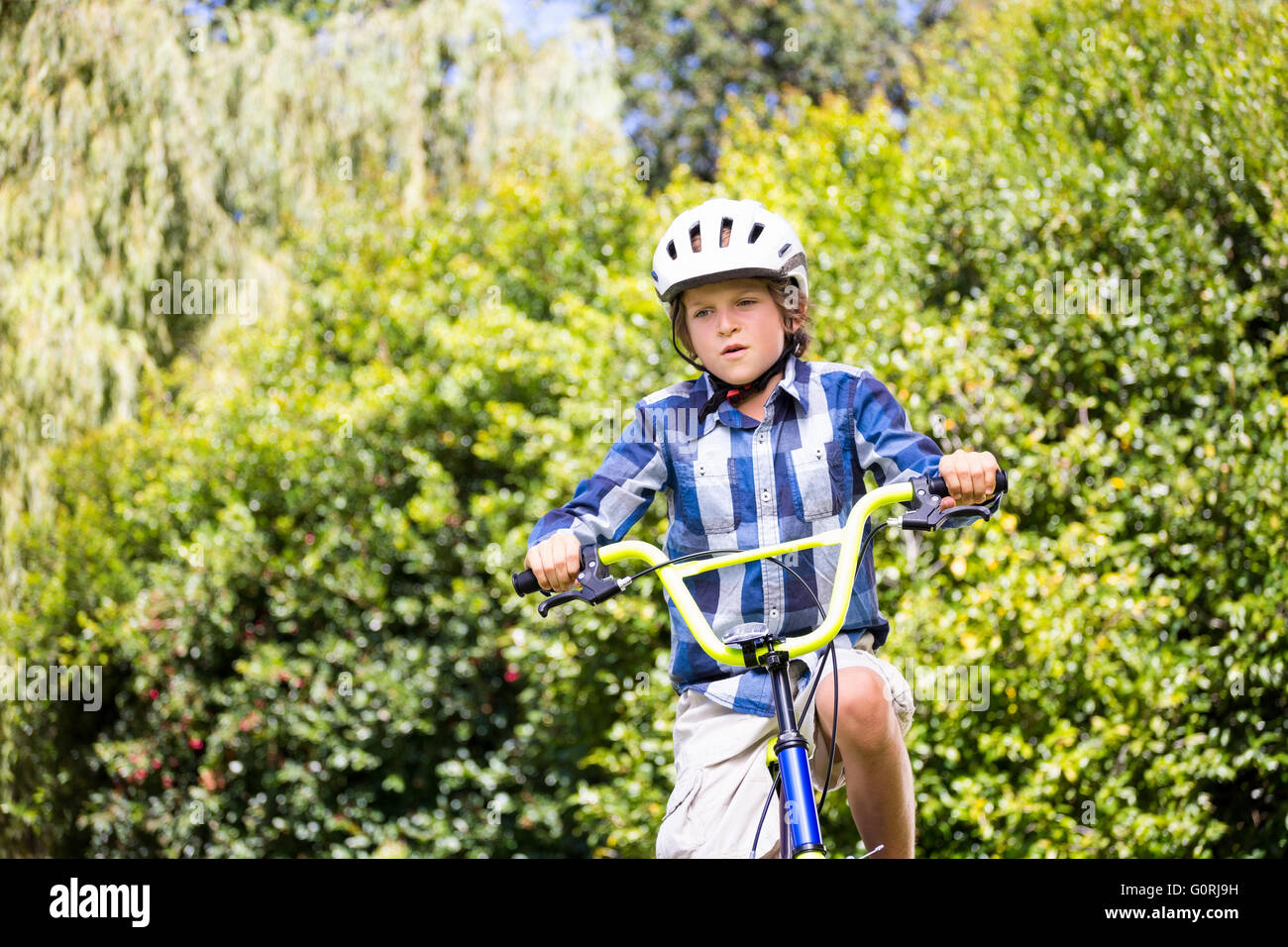 Portrait of boy smiling and riding bike Stock Photo