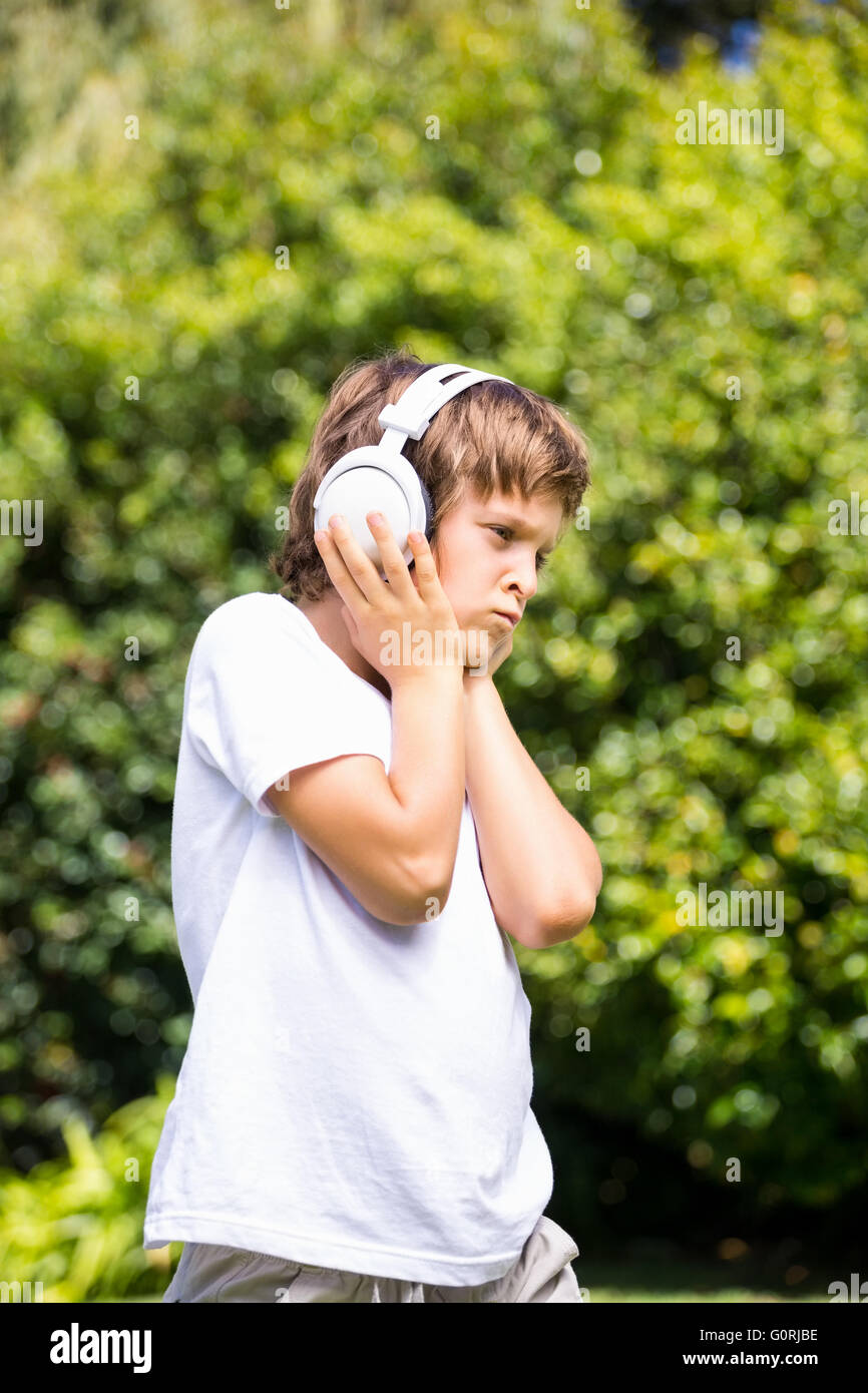 Grimacing child listening music Stock Photo