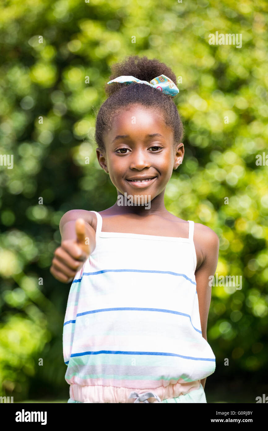 Mixed-race girl throwing up thumb Stock Photo