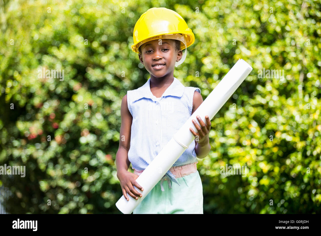 Cute mixed-race girl wearing handyman clothes Stock Photo