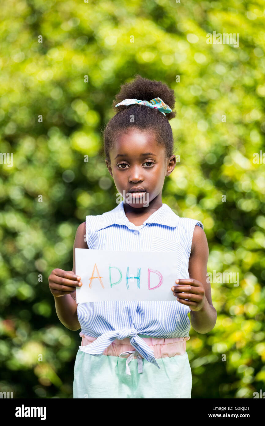 Cute mixed-race girl holding a paper with a message Stock Photo