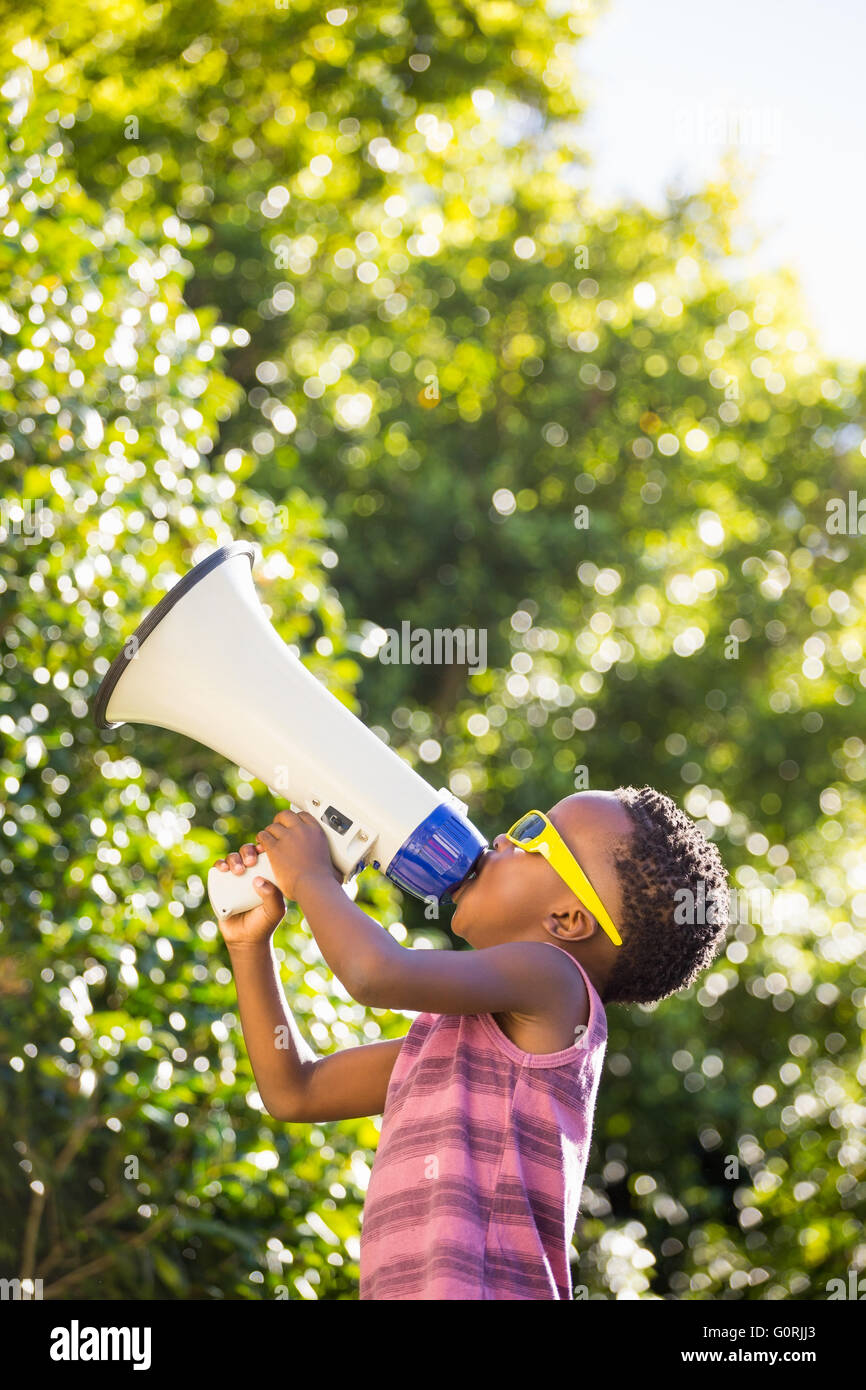 Boy shouting trough a megaphone Stock Photo