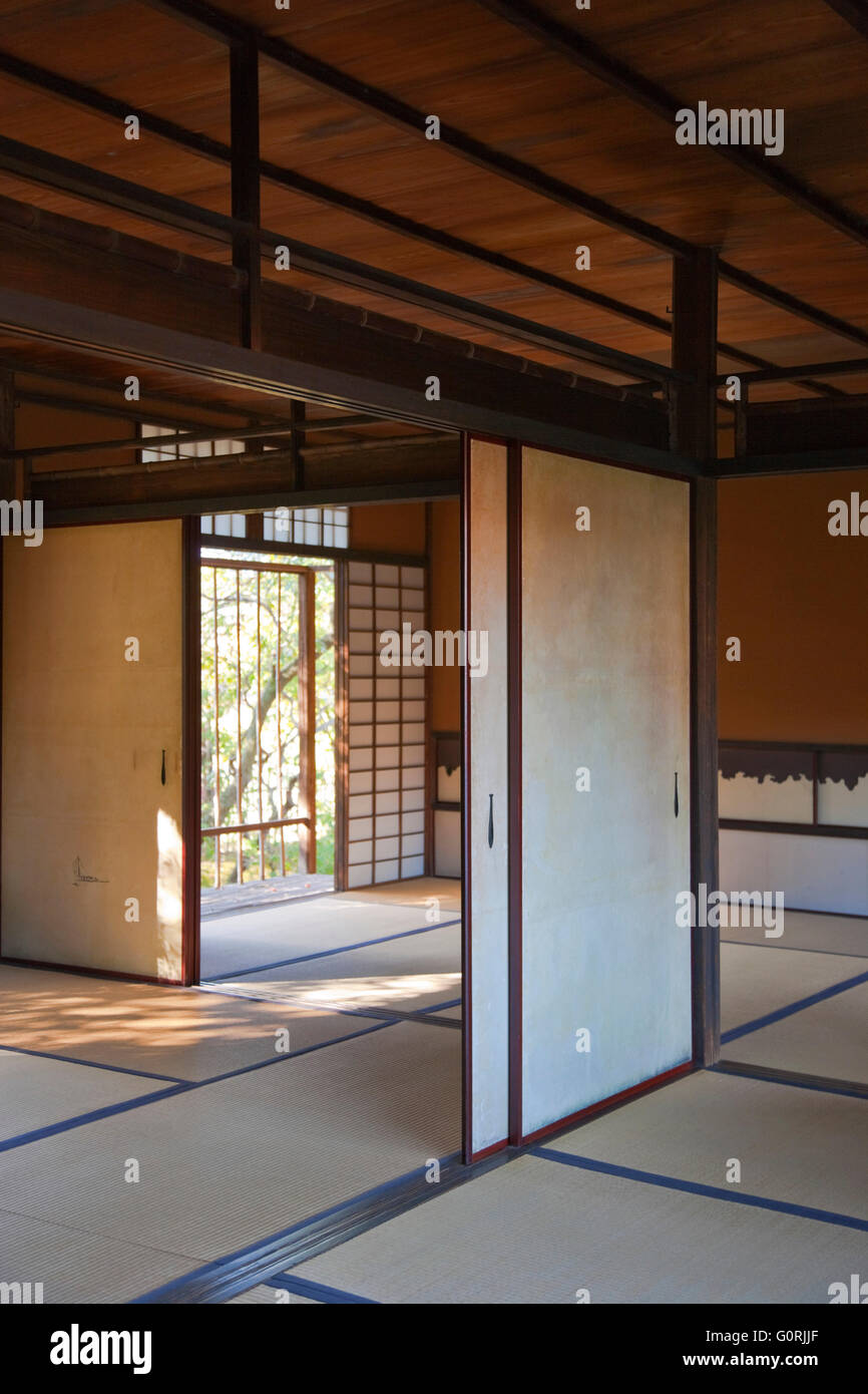 An interior naturally-lit view shows the traditional tatami mat floors and fusuma sliding doors (with oar-shaped door pulls) of Shoi-ken tea pavilion inside Katsura Imperial Villa, in the southwest area of Kyoto, Japan. Stock Photo