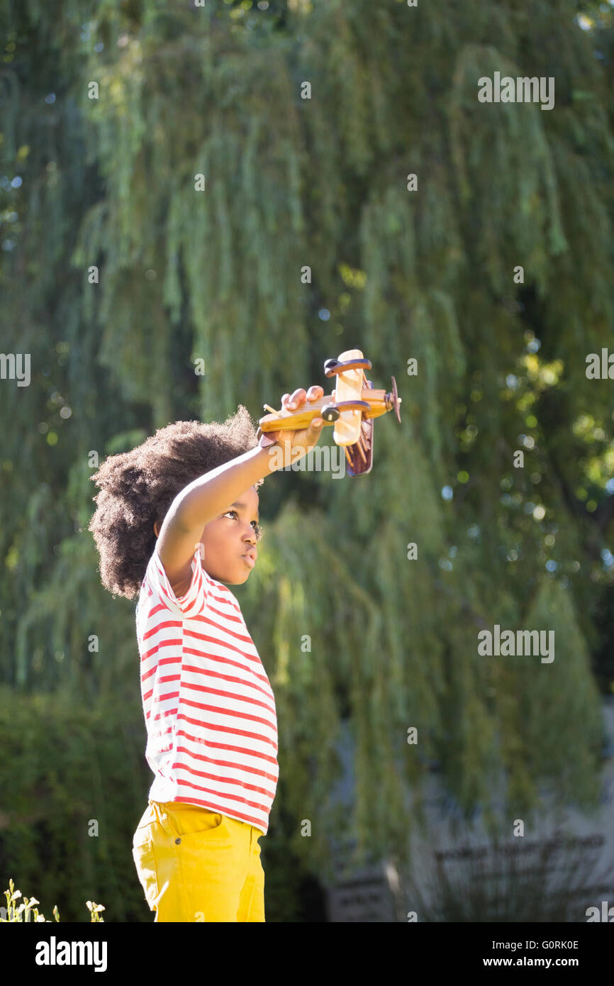 Boy is playing with a toy plane Stock Photo - Alamy