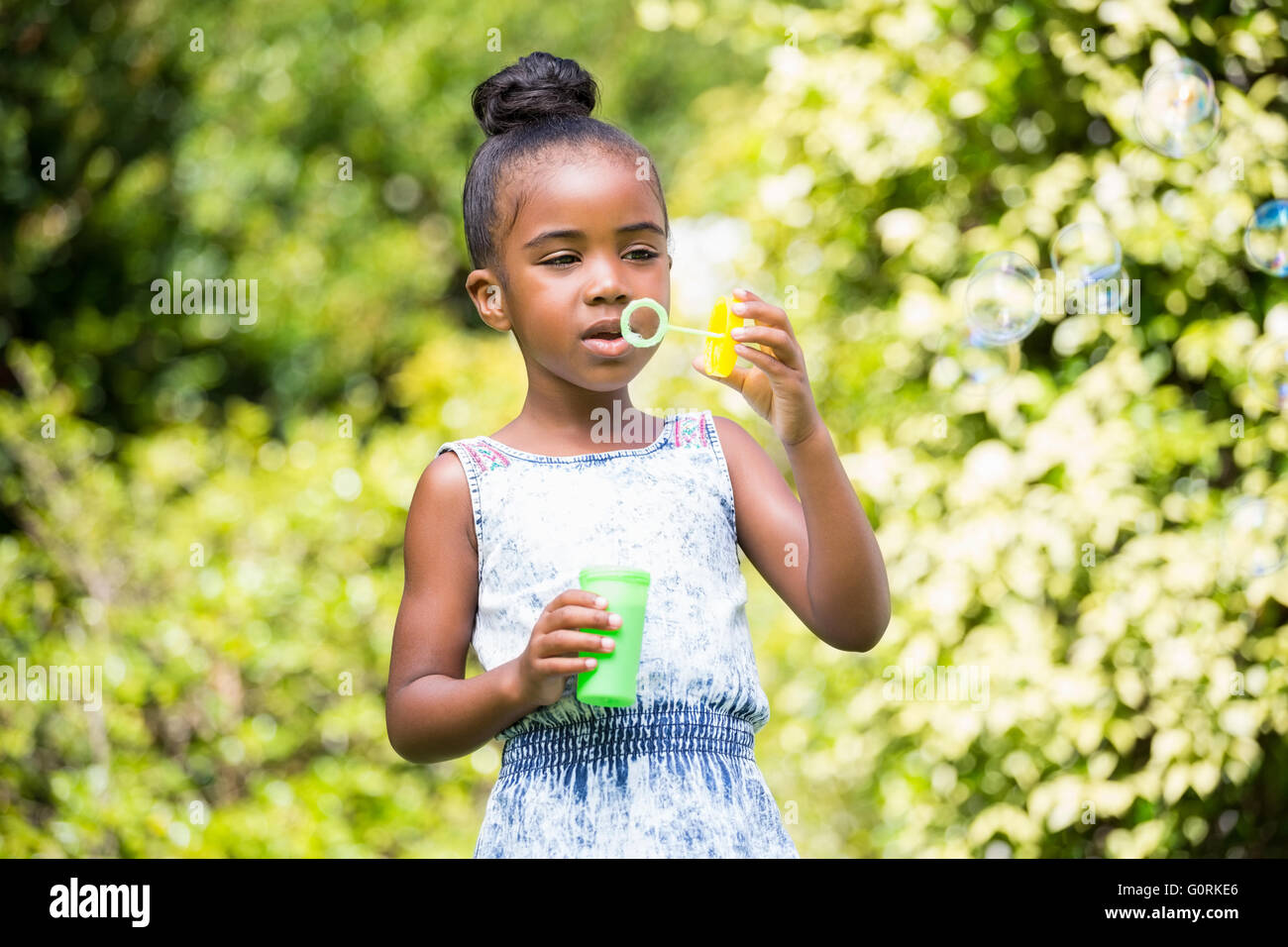 Little girl making bubble at park Stock Photo