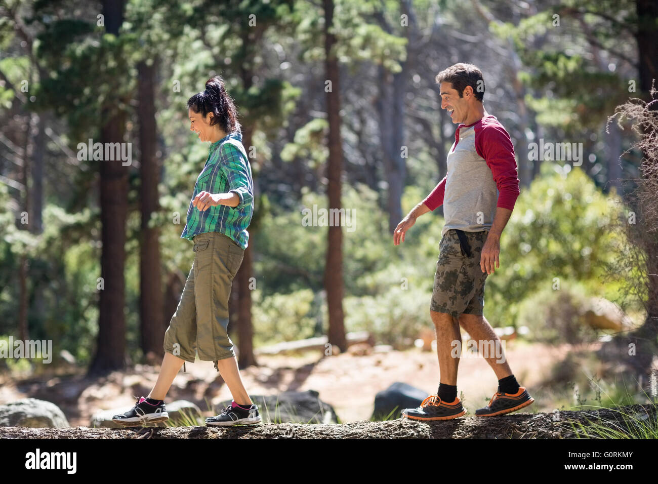 Couple smiling and walking with balance Stock Photo