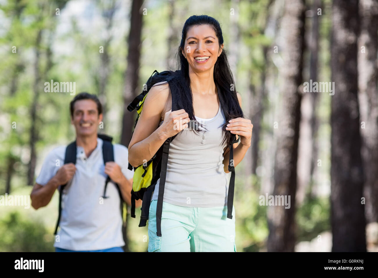 Couple smiling and posing with their backpack Stock Photo