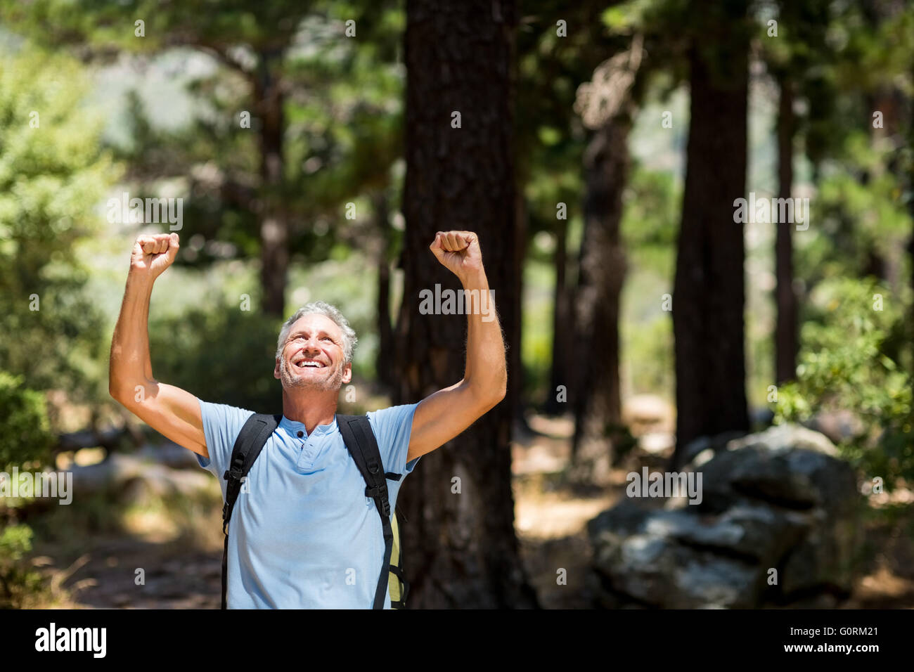 Hiker smiling and throwing arms Stock Photo